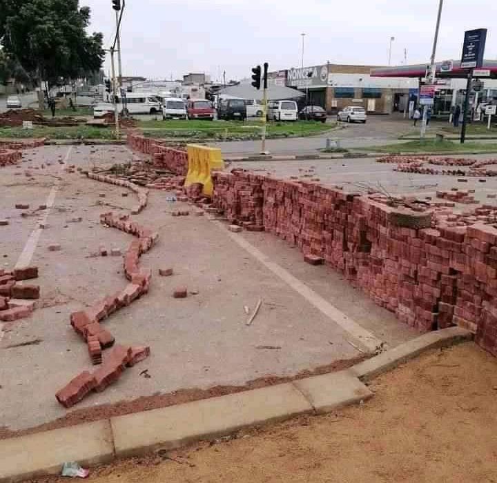 Residents of Pimville building a wall across the street of their busiest route, using thousands and thousands of bricks to raise the wall